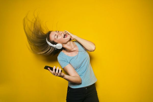 Girl with headphones singing