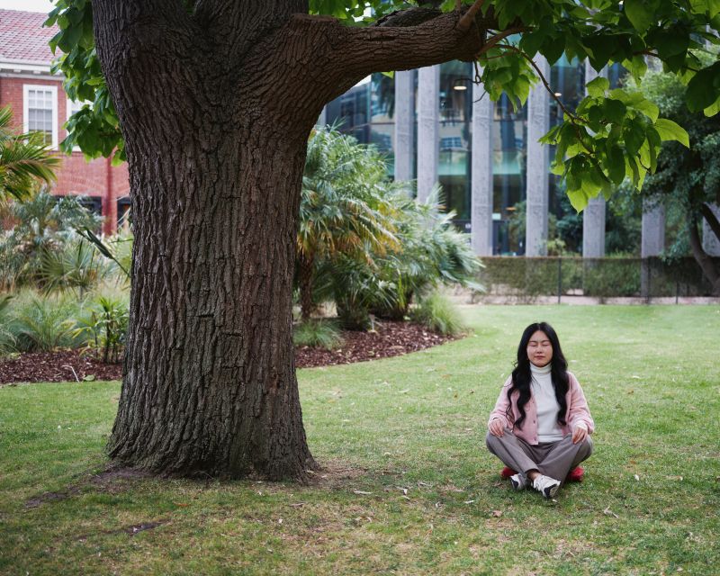 Woman meditating under a tree