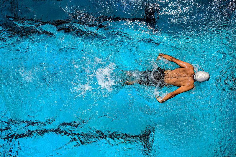 An aerial view of a swimmer in an Olympic pool.