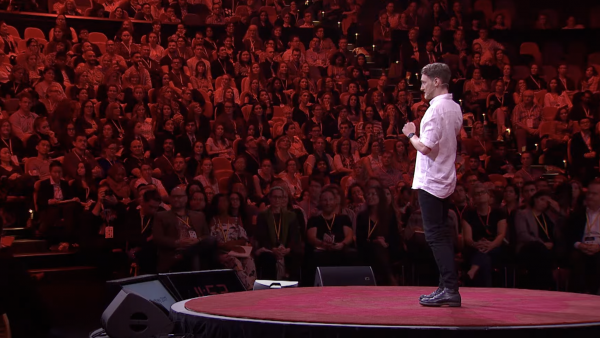 An image of Scott speaking to a large crowd