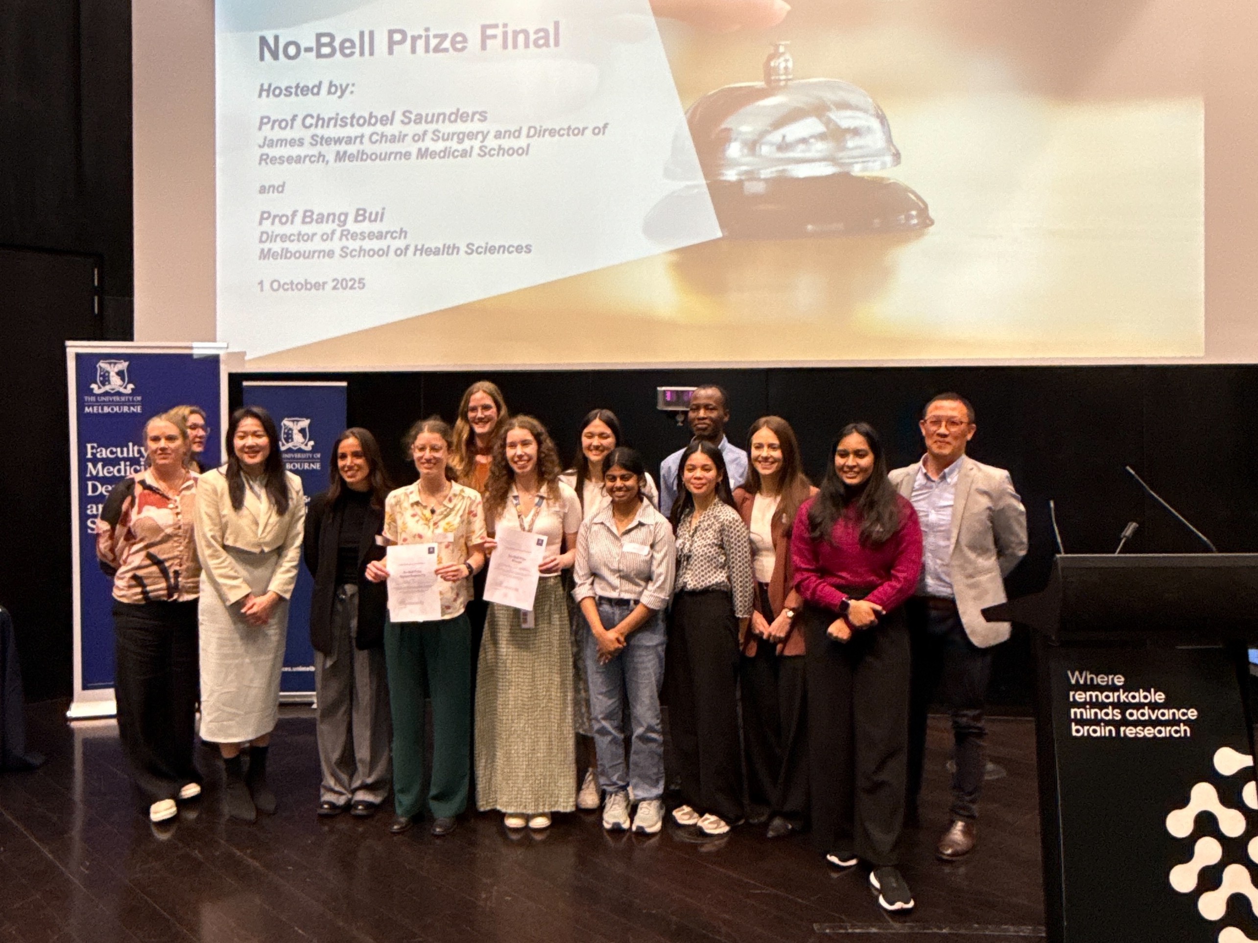 2025 No-Bell Prize finalists pose in front of a banner.