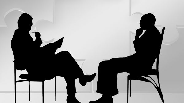 digital image of two men sitting across each other, as in a consultation