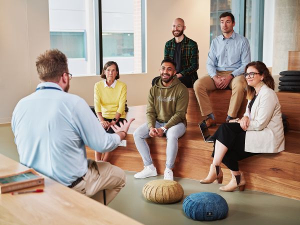 A teacher chatting to a room of students
