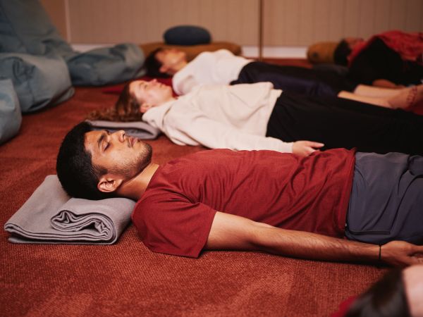 People meditating lying down