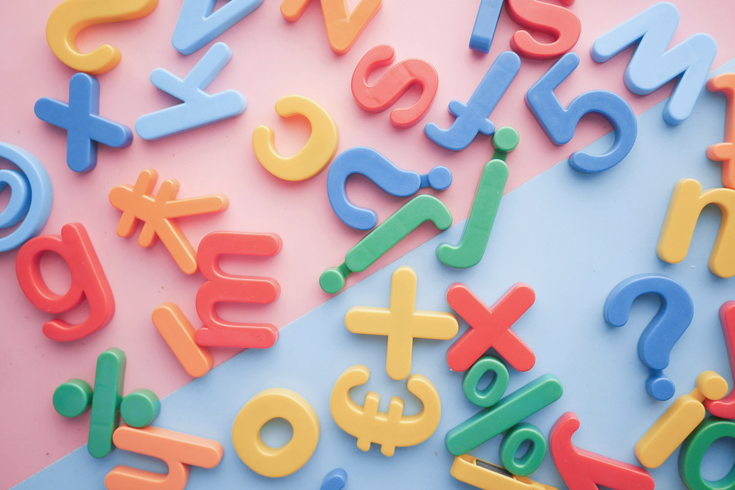 Coloured letter magnets scattered across a table.